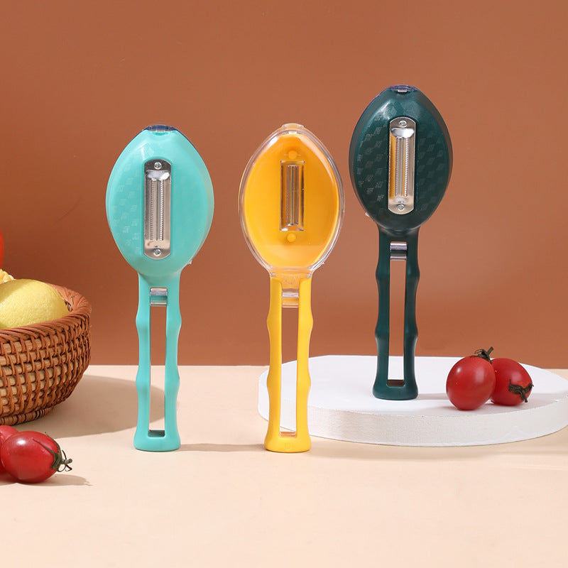 Kitchen peeler with integrated blade cover in use peeling vegetable