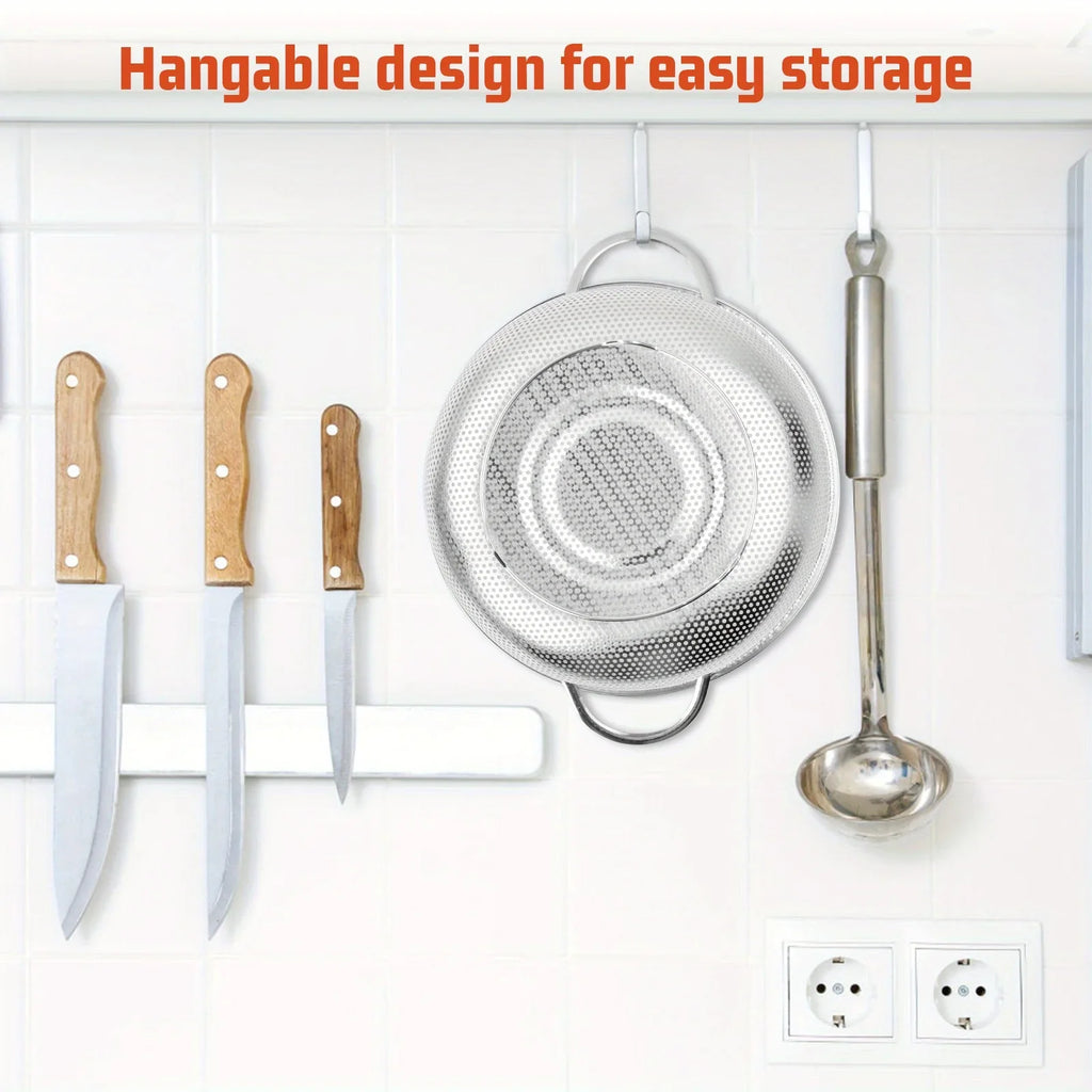 Fine mesh strainer rinsing vegetables with handles resting base