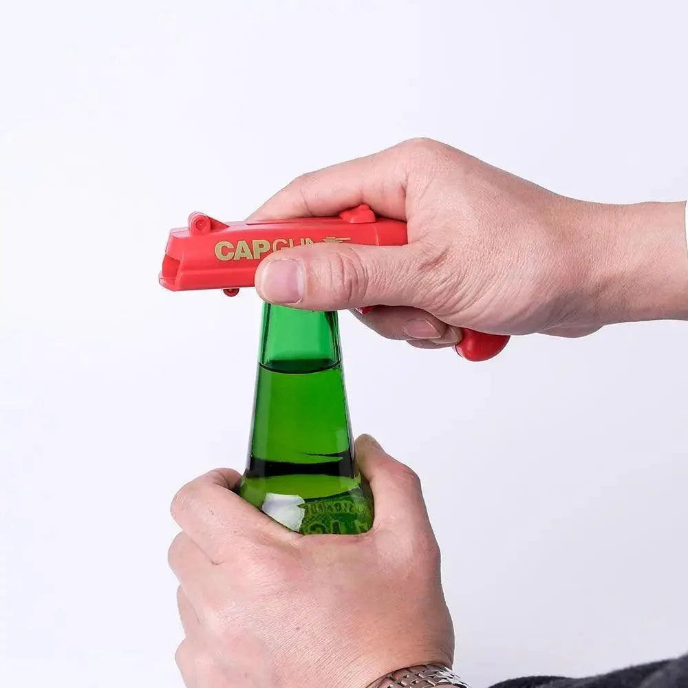 Fun bottle cap launcher opener being used at party bar tool