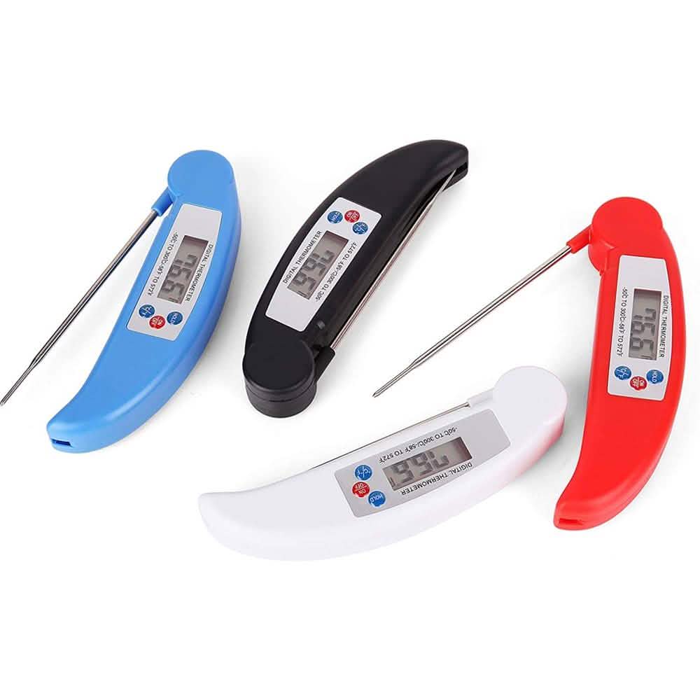 Digital meat thermometer in use checking steak temperature on grill