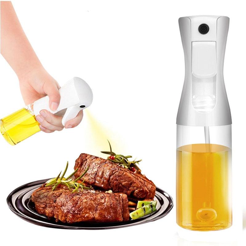 Oil spray bottle misting olive oil on salad kitchen cooking tool